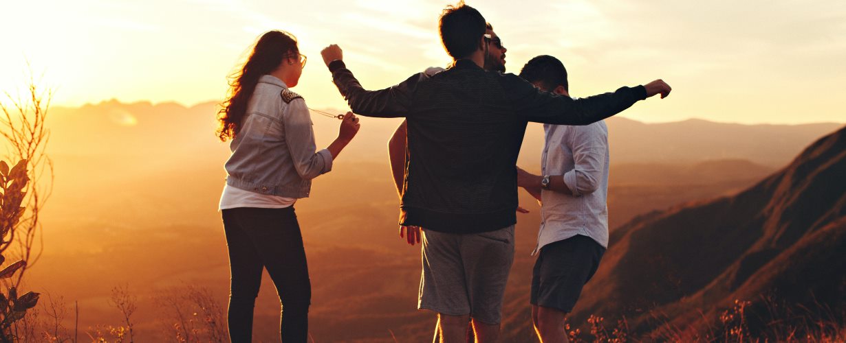 Young people on a mountain top. Photo by Helena Lopes from Pexels
