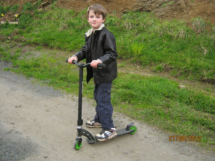 Adam as a small boy on his scooter